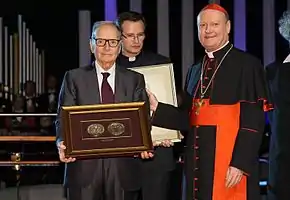 Ennio Morricone receives the Per Artem Ad Deum Medal from Archbishop Gianfranco Ravasi (2012)
