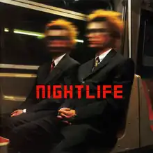 Two people wearing business clothing are seated while riding on the subway. A motion blur affect is shown at the heads of the individuals.