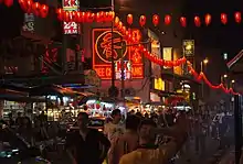 Crowded city street, with red lanterns