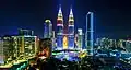 Petronas Twin Towers illuminates in the Malaysian flag colours