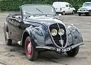 Peugeot 202 cabriolet.  The protected position of the headlights behind the grill became a key identifier for the Peugeot brand during the 1930s