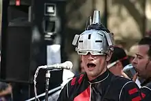 Joebot wearing a silver helmet.