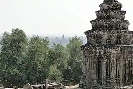 Stone tower and Angkor Wat far afield