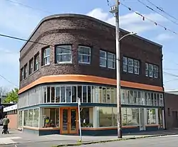 Photograph of a two-story commercial building on a city street corner