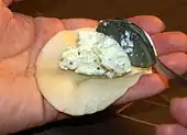 Placing the filling into a dough pocket