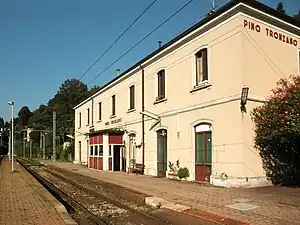 Two-story stuccoed building with gabled roof