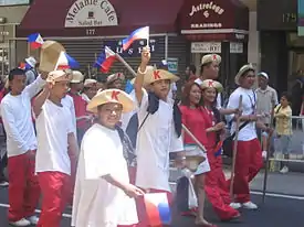 Photograph of young male and femal Filipinos dressed as Katipuneros in Midtown Manhattan.