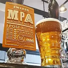 Pint of Manchester Pale Ale next to a pump clip