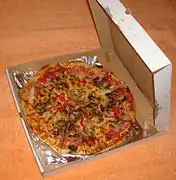 Pizza served in a cardboard box.