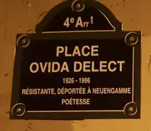 A plaque and street marker with the name of Ovida Delect.