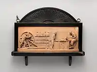 Somewhat untypical terracotta plaque (wood frame) depicting a pottery workshop, c. 1882