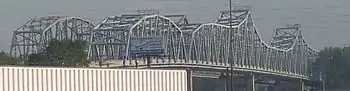 A pair of bridges, with of lot of steel trusses.