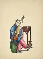 Woman wearing a blue ao/shan and pink trousers