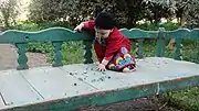 Egyptian toddler playing with glass marbles