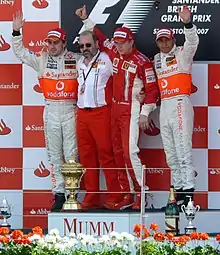 Left to right: Fernando Alonso, Gilles Simon, Kimi Räikkönen and Lewis Hamilton on the podium of the 2007 British Grand Prix