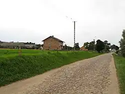 Houses by the unpaved road in Łaś-Toczyłowo