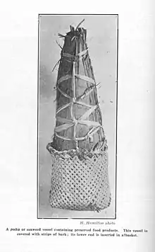 A pōhā covered with tōtara bark and inserted into a flax basket
