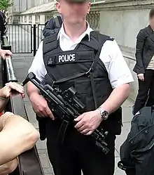 Police officer from Met police London England Uk at Downing Street security holding an MP5A3.