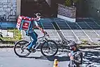 A bicyclist and a police officer wearing masks in Santa Fe