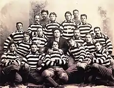 Group photo of the Pomona football team wearing thick striped shirts