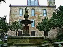 The building and the 1876 fountain designed by Alejandro Sesmero with the sculpture of the Roman goddess Fama