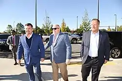 Governor Larry Hogan and other officials gathered at Port Covington, Baltimore for a press conference in 2018. Under Armour sign visible in background.