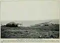 View of part of Port Dezhnev, 1913.  The American-style cabins near the lagoon are probably a trading station.