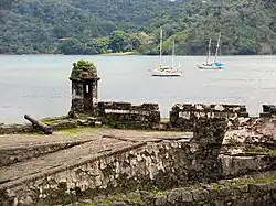 Ruins of a fort near water.