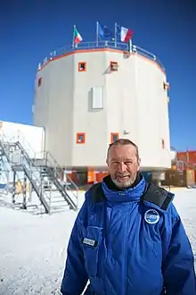 Chappellaz standing in front of an Antarctic research station