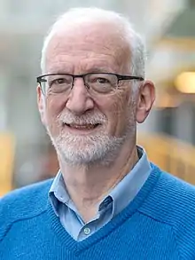 Portrait of Distinguished Professor Emeritus Frank Tompa taken in the Davis Centre at the University of Waterloo