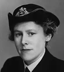 Monochrome portrait photograph of Rundle. She is shown dressed in her WRNS uniform and wearing a naval cap on her head.