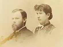 Sepia photograph of a man and woman in profile.