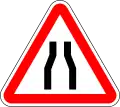 Road narrows on both side