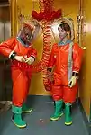 CDC microbiologists in Delta Protection "Orange Suits"