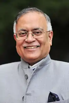 Head and shoulders portrait of Pradeep Kumar Kapur wearing Indian dress with pocket square.