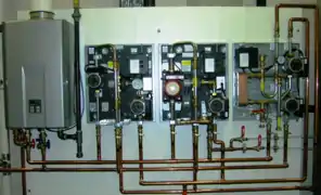 Modern factory assembled hydronic control appliances for underfloor heating and cooling, shown with covers off