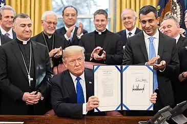 Archbishop Bashar Warda's participation in the signing of the H.R. 390 in the White house in 2018 representing Iraqi Christians.