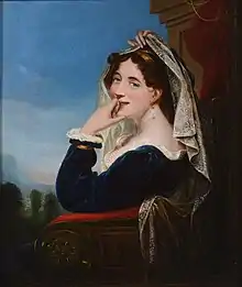 Woman sitting in an elaborate wooden armchair, with its side towards the viewer. The woman herself has turned towards us, lifting a white lace veil from her face and smiling. She is wearing a simple, dark blue dress lined with white lace, a golden bracelet, and a long pearl in her visible ear. Her hair, mostly hidden under the long veil, is brown and curly with golden ribbons or straps in it, her eyes are blue.