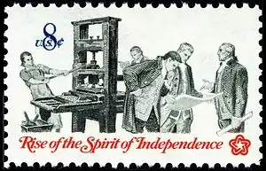 Patriots utilizing a printing press while examining a colonial pamphlet