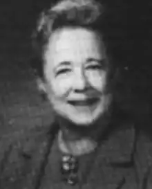 A smiling middle-aged white woman wearing a suit