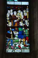 Stained glass in the south nave aisle depicting the procession of the drapers in the early sixteenth century