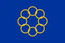 Flag featuring 8 golden interlocked rings on a blue background.
