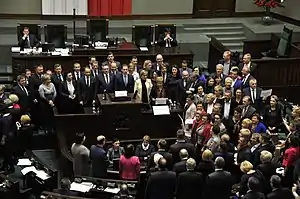 Opposition MPs in the Polish parliament holding placards and protesting