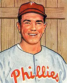 A baseball card image of a smiling man wearing a gray baseball jersey with "Phillies" in red across the chest and a red baseball cap with a white "P" on the front
