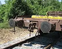 Buffers and chain coupler on goods wagon. The chain hangs on the towing hook
