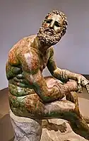 Bronze statue of a boxer resting after a bout