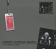 A photo of Jerry Garcia as a stage magician conjuring a guitar from out of a hat, and a backstage pass for the Jerry Garcia Band