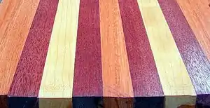 A board laminated with Purpleheart (the darkest of the three), as well as the lighter colored cherry and the salmon colored Lyptus.