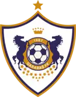 Shield-shaped football-club logo of a football surrounded by two rearing horses