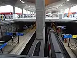 The four RER B tracks and two platforms are visible under the station's concrete canopy